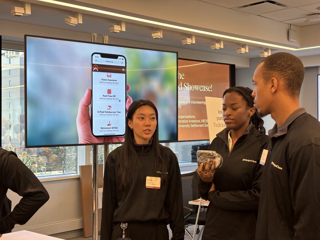 Team members presenting the CASES site on a phone at the showcase event