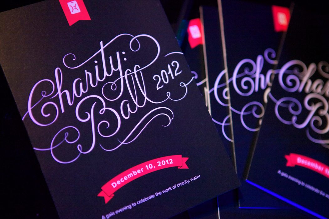 Charity: ball 2012 invitation in black with violet script lettering and a pink ribbon