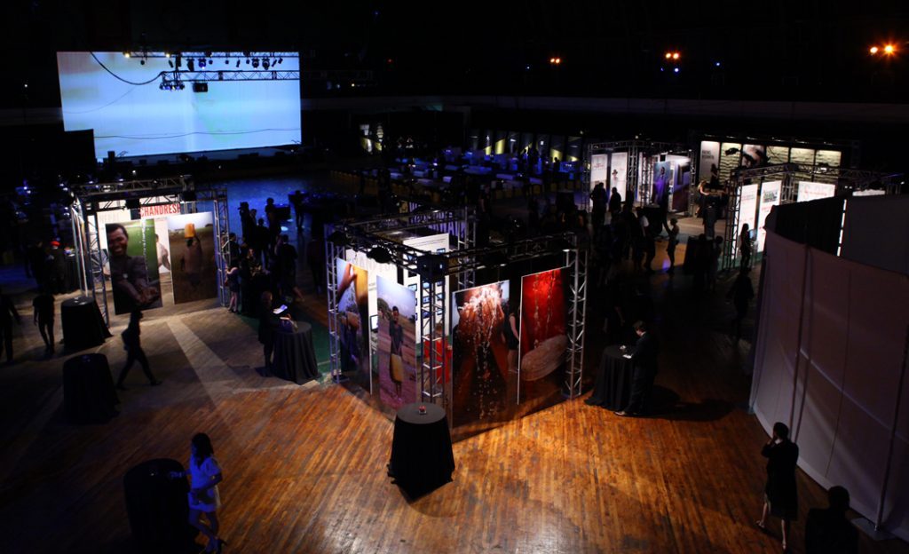 Overview of the charity: ball exhibition floor with illuminated panels and guests