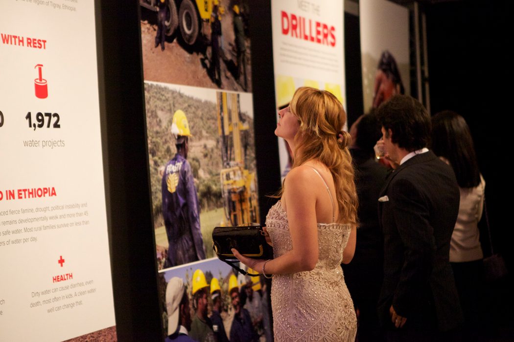 Guest viewing "Meet the drillers" exhibition panels at the event