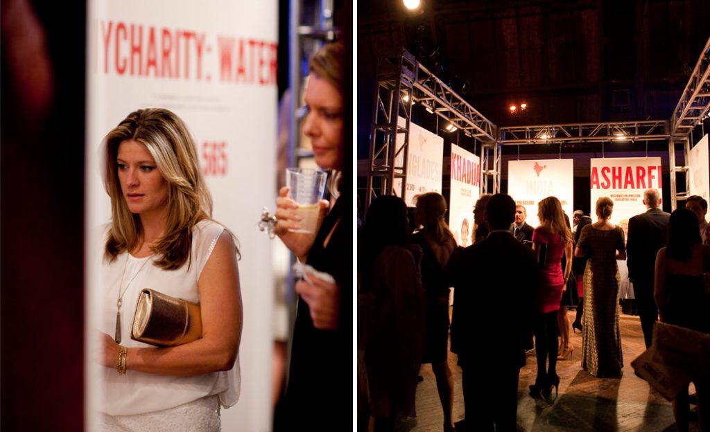 Guest holding a drink beside exhibition panels as attendees mingle