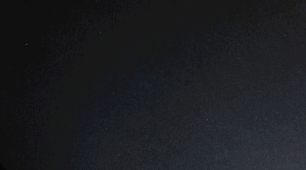 Animation of a hand stamping the charity: water seal onto black paper