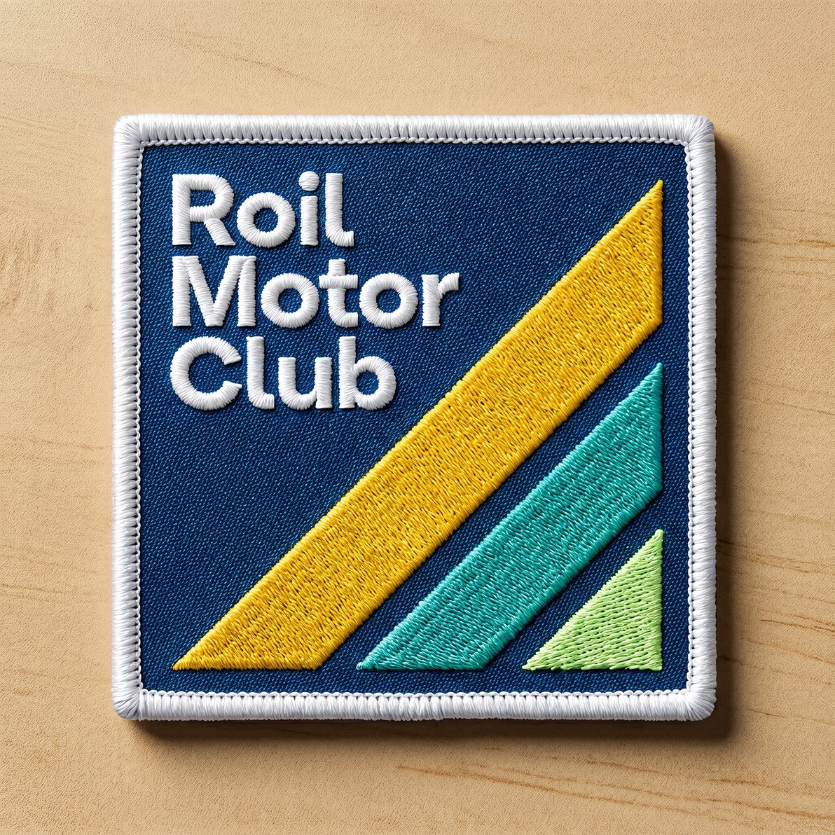 Embroidered Roil Motor Club patch on a wood surface