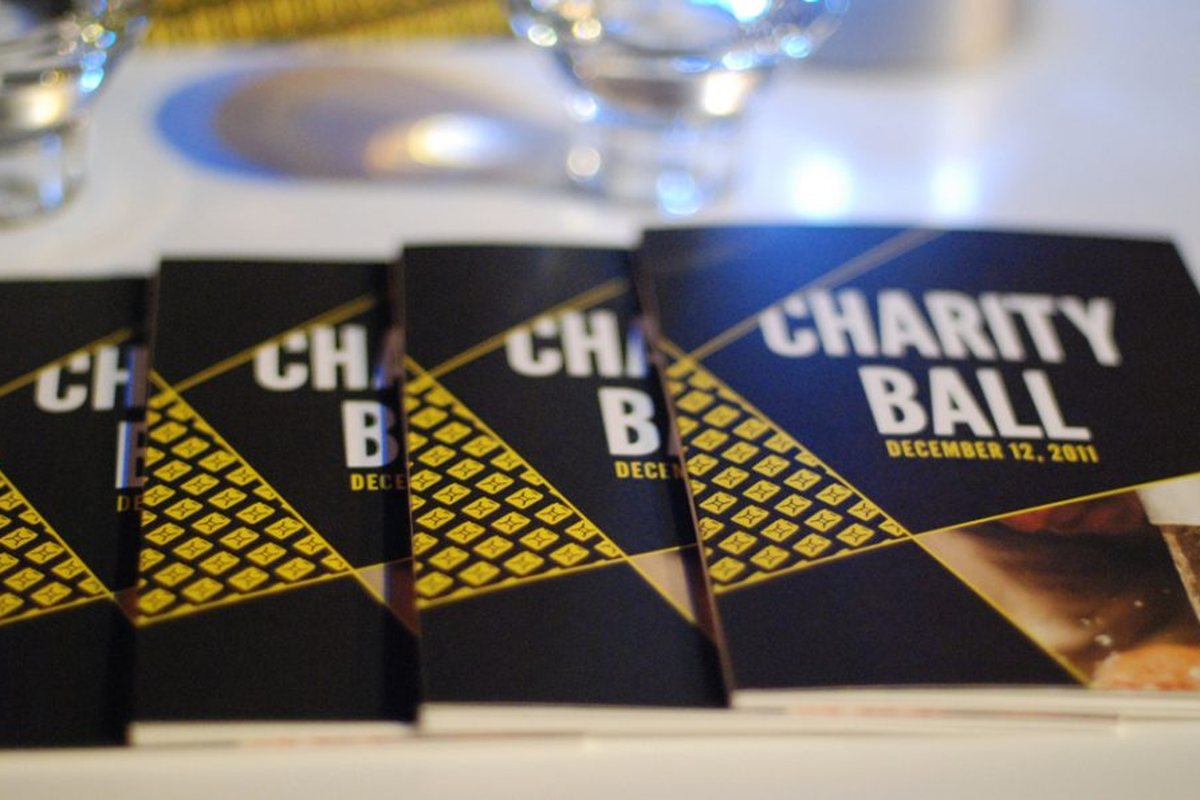 charity: water Charity Ball programs on a dinner table