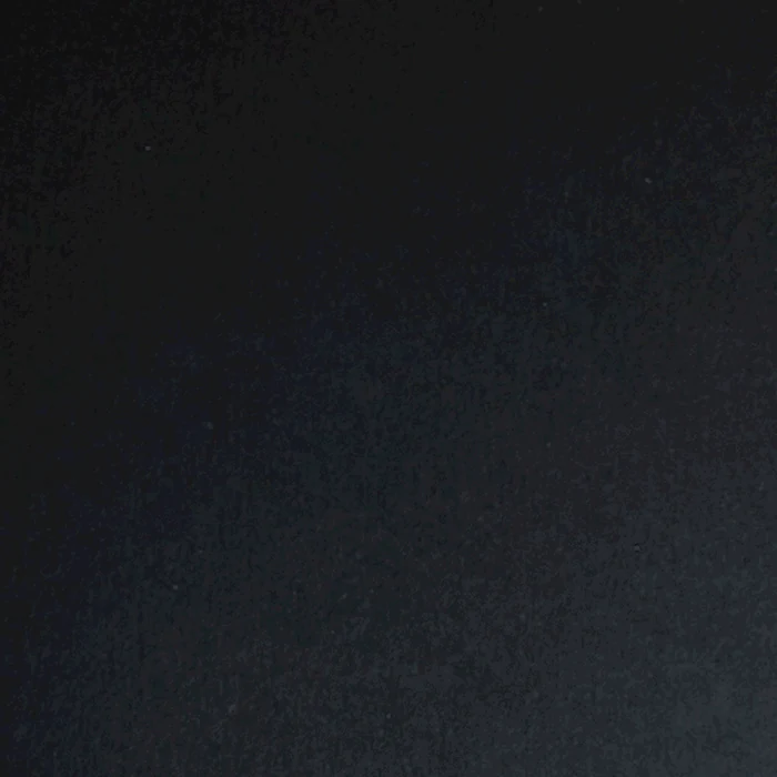 A charity: water stamp being pressed onto dark paper