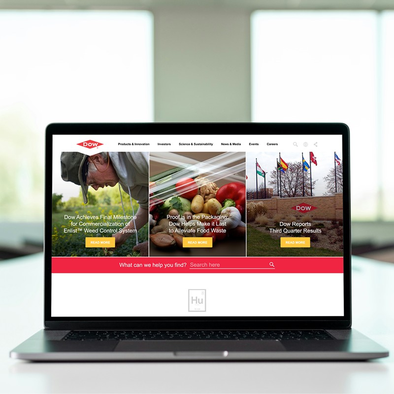 Redesigned Dow.com home page open on a laptop on a desk